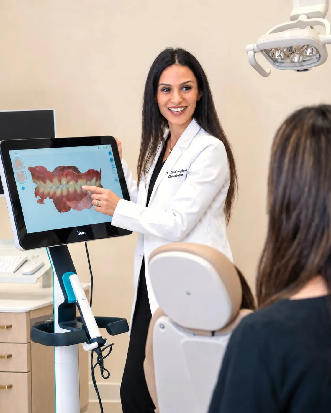 Dr. Haykani walking a patient through her digital scan on screen