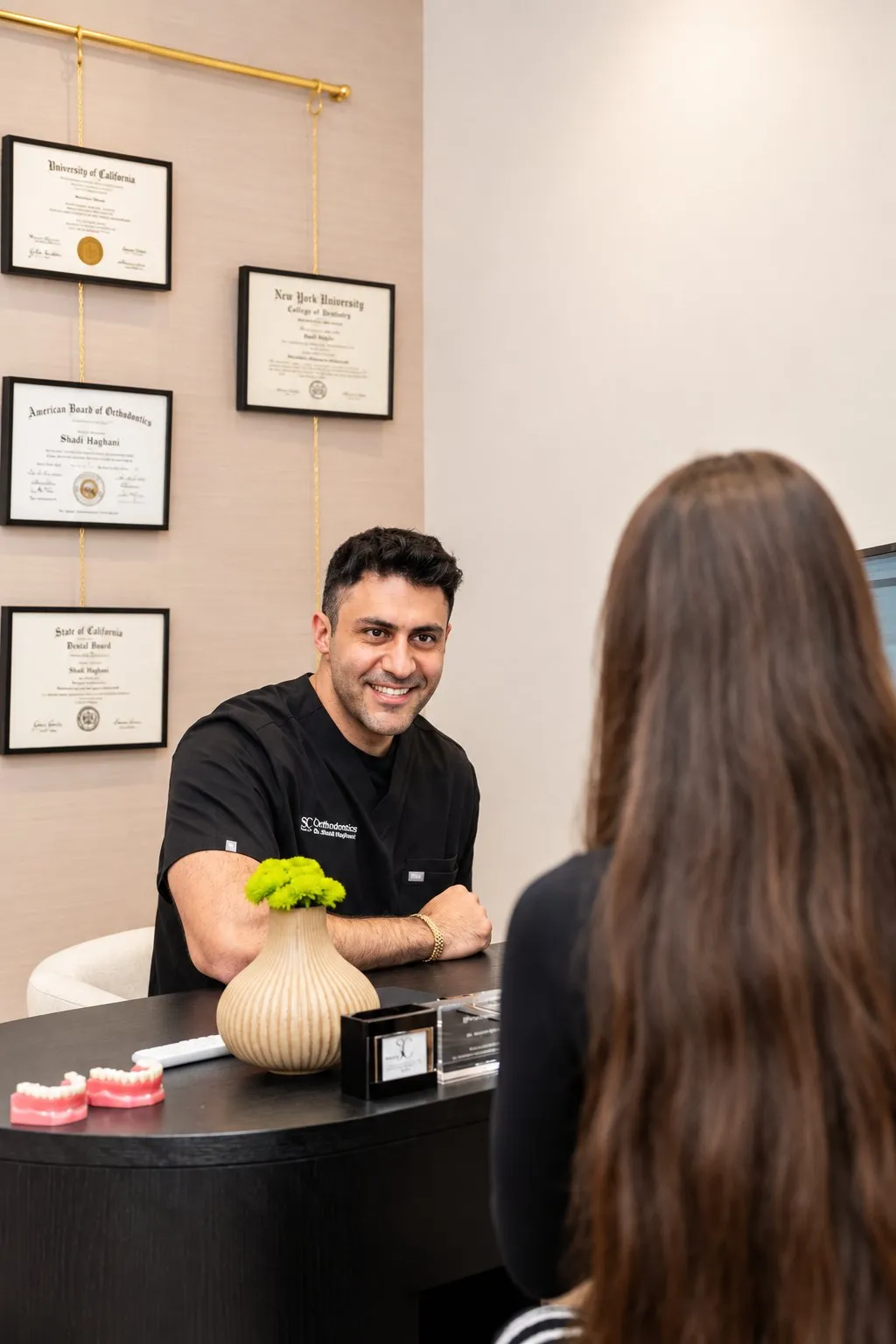 Kevin Cohenmehr, treatment coordinator, reviewing a payment plan with a patient at SC Orthodontics in Valencia