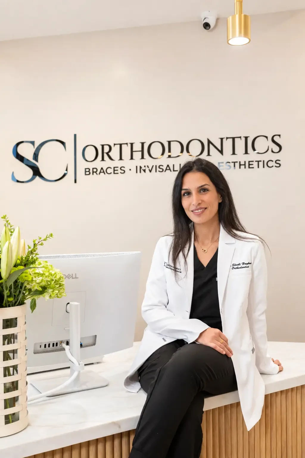 Dr. Shadi Haykani seated at the SC Orthodontics front desk in Valencia