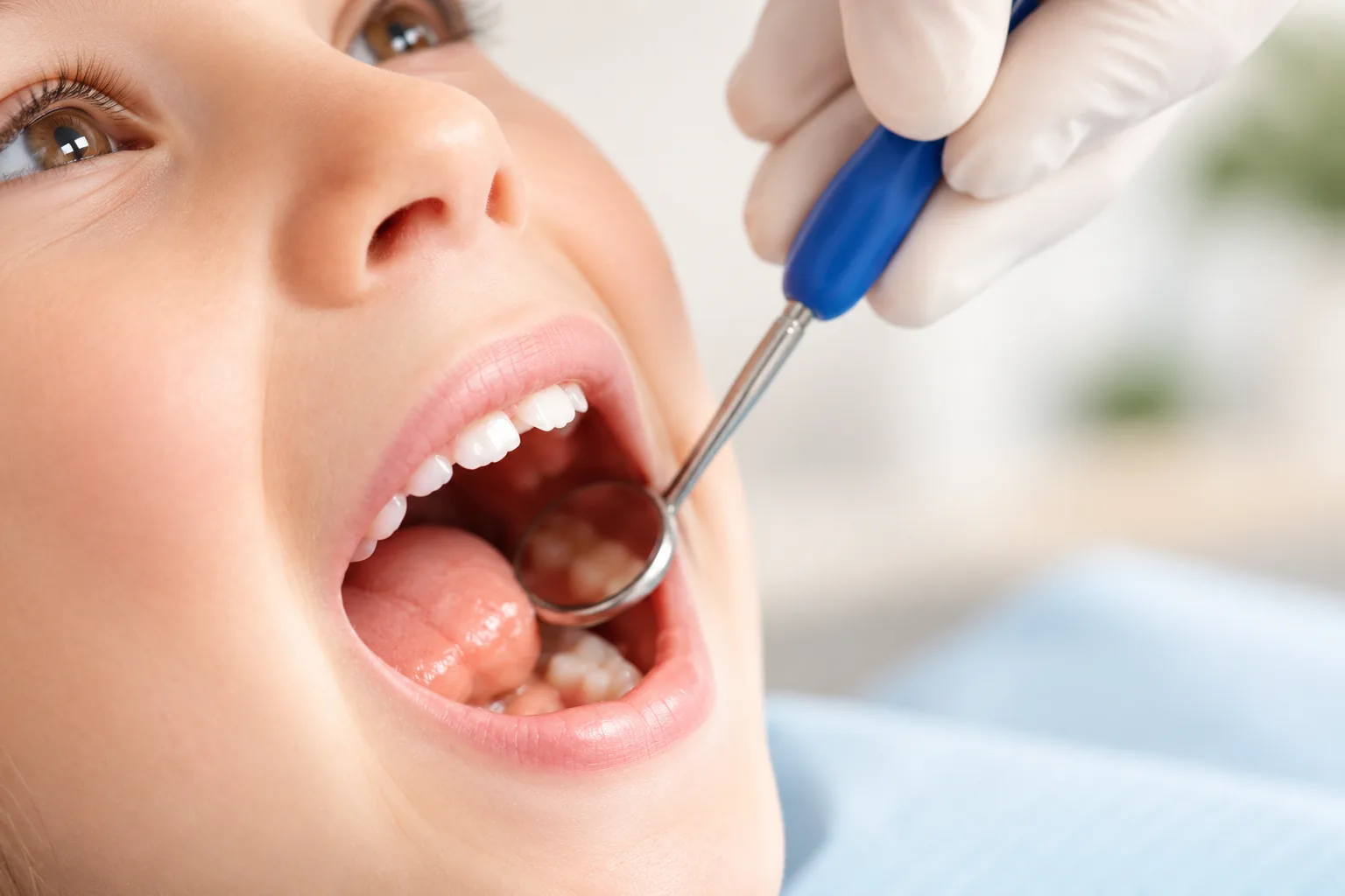 A child’s orthodontic evaluation with a dental mirror