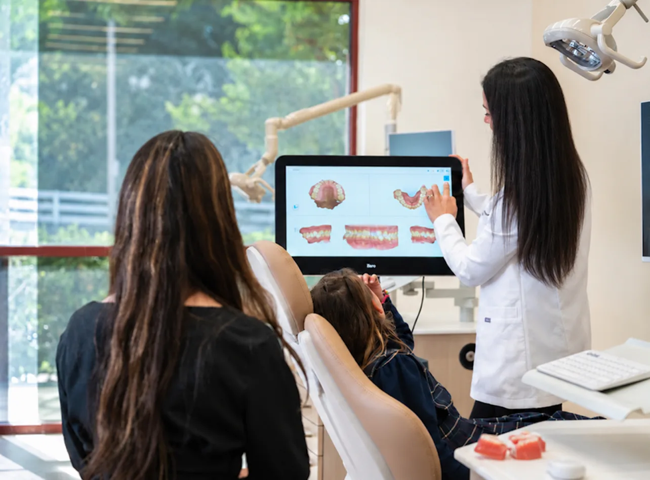 Dr. Haykani reviewing digital scans on screen with a patient and parent at SC Orthodontics in Valencia